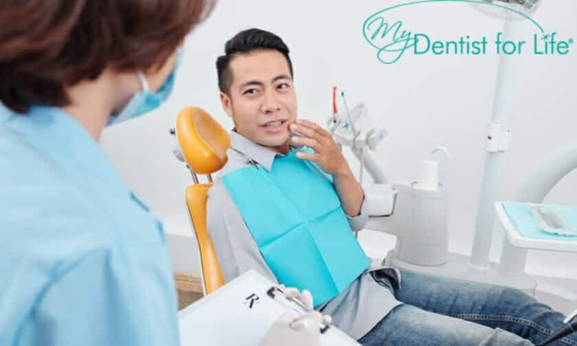 Patient in dental chair discussing gum pain treatment with dentist at My Dentist For Life in Plantation, FL.