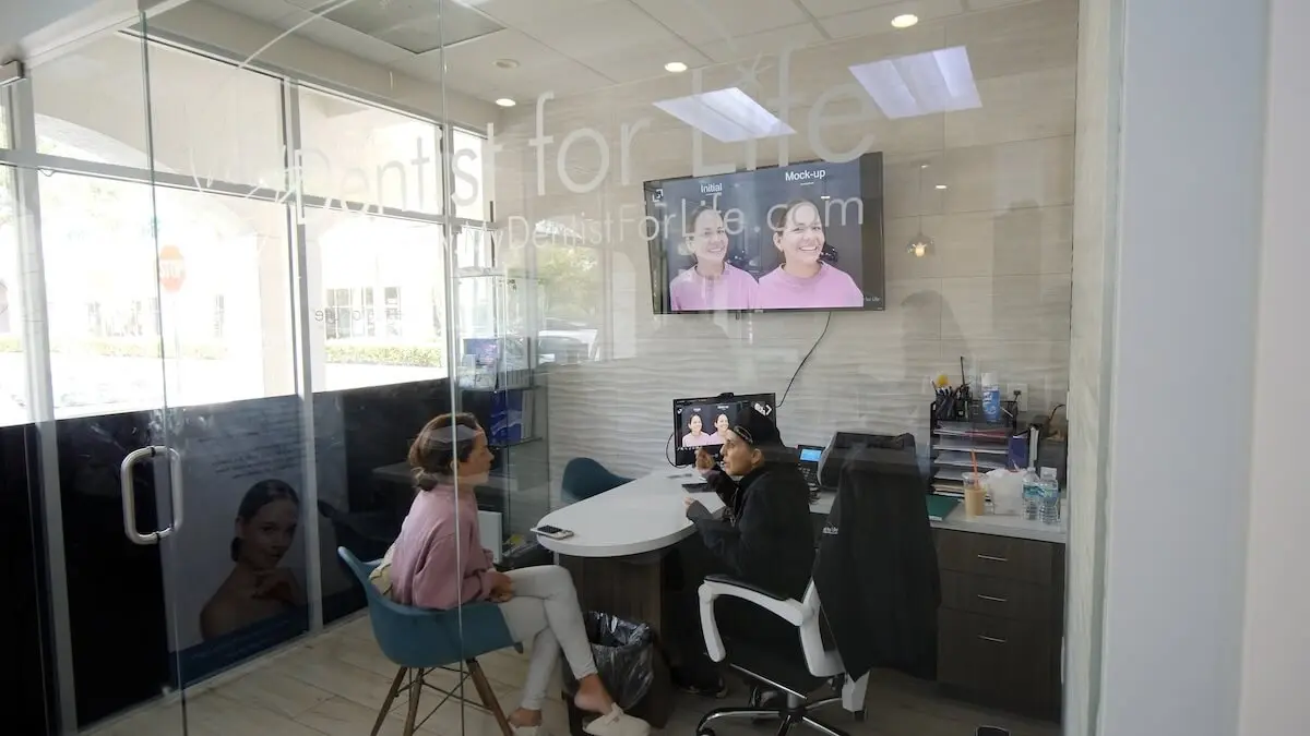 Two dental professionals conduct a 3D facial design consultation in a modern office in Plantation, FL.