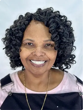 Smiling woman with healthy teeth after All-on-X dental implants in Plantation, FL.