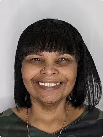 Smiling woman with All-on-X dental implants showcasing her new smile.