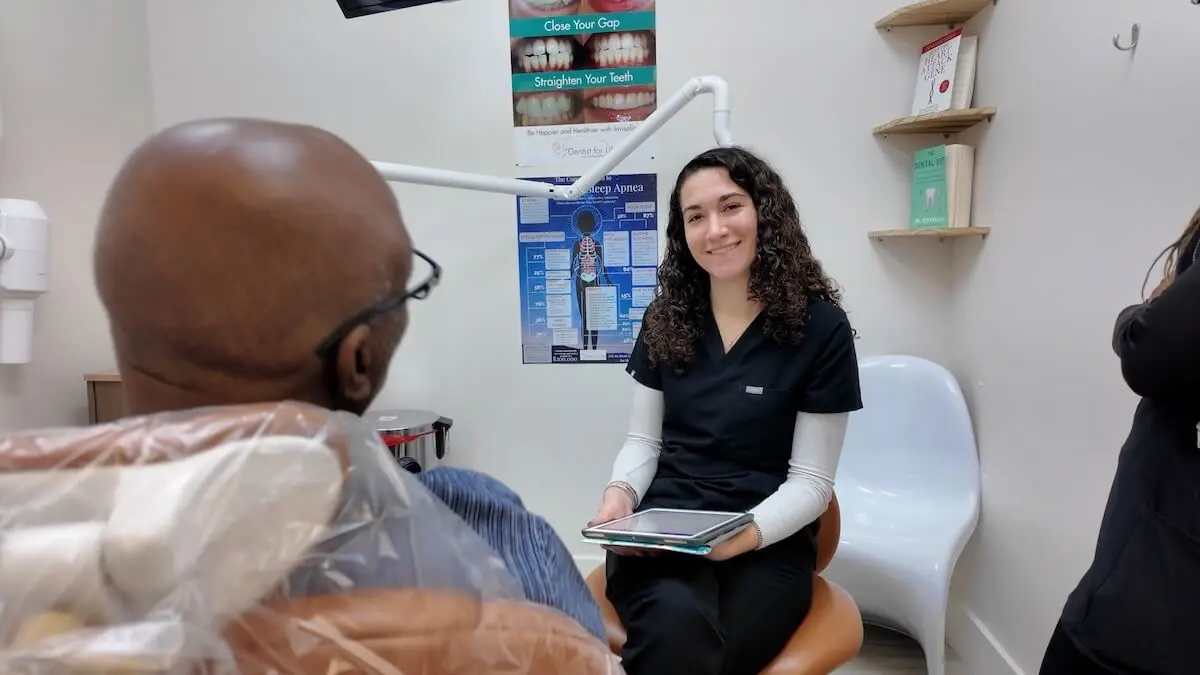 Dental hygienist consulting with patient about gum lift treatment in Plantation dental office.
