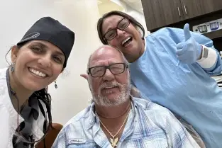Smiling dental team members posing together in a Plantation, FL dental practice.