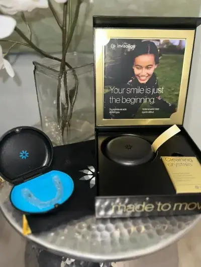 Invisalign clear aligner case and promotional materials displaying smile transformation messaging.