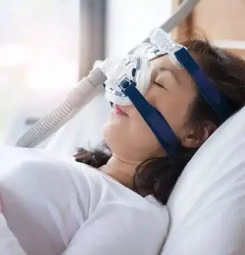 Patient wearing CPAP mask for obstructive sleep apnea treatment in Plantation, FL.