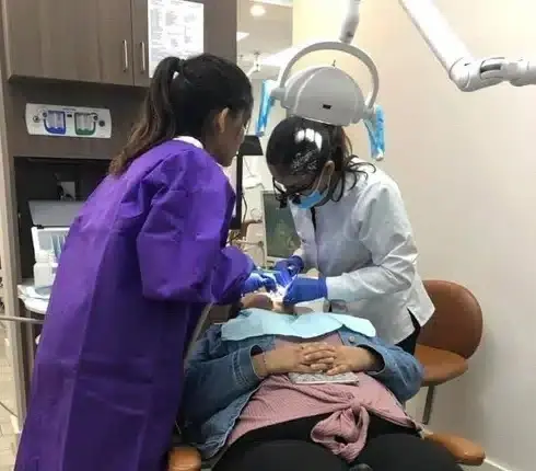 Dentist performing ozone dental treatment on patient in Plantation, Florida office.