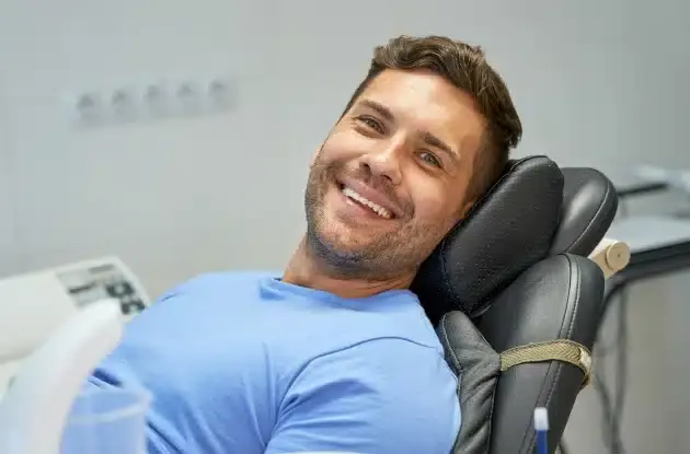 Smiling male patient relaxed in dental chair during sleep apnea consultation in Plantation, FL.