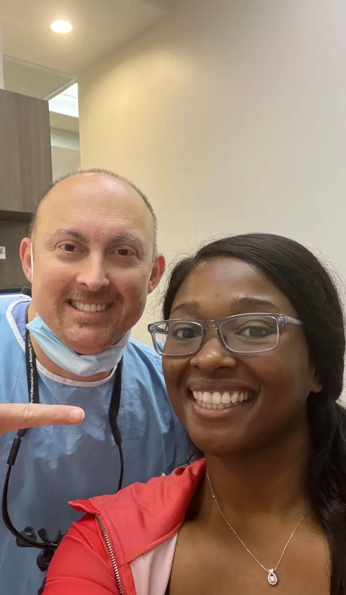 Smiling dentist and female patient together at dental practice in Plantation, FL.
