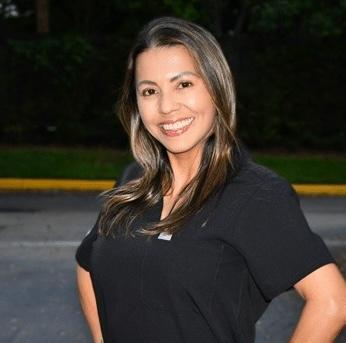 Betty, dental team member at Plantation, FL practice, smiling outdoors.