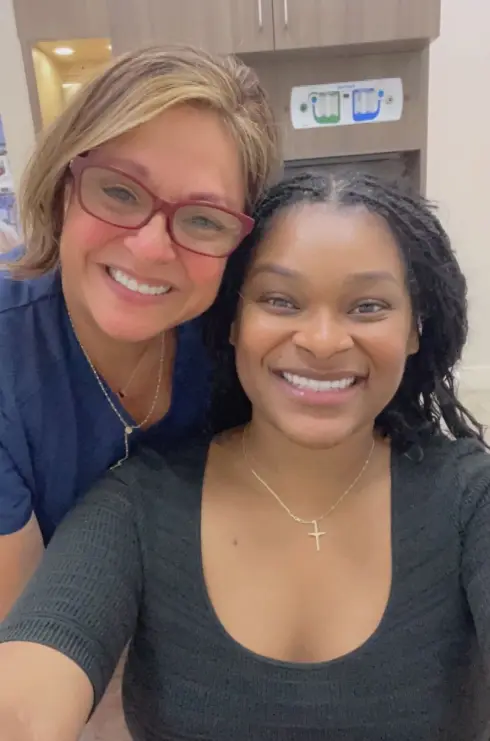 Two smiling women at a dental practice in Plantation, FL.