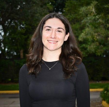 Brooke, a dental team member at Plantation dental practice, smiling outdoors.