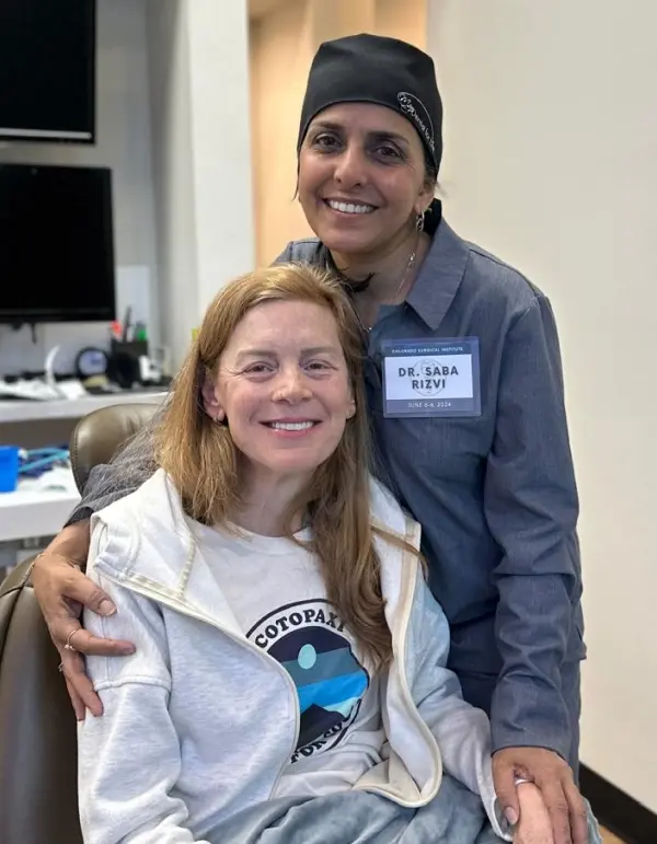 Dr. Saba Rizvi smiles with a patient at her cosmetic dental practice in Plantation, Florida.