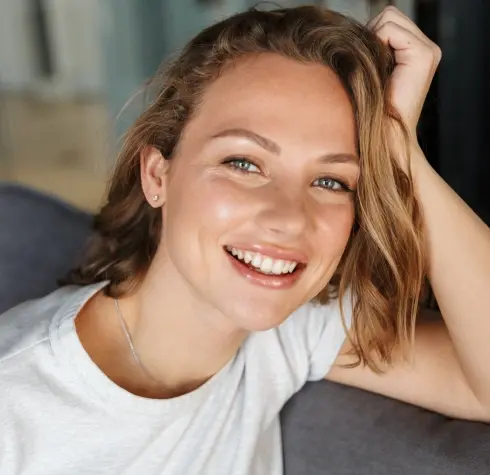 Happy woman with a bright, healthy smile showcasing facial esthetics results in Plantation, FL.