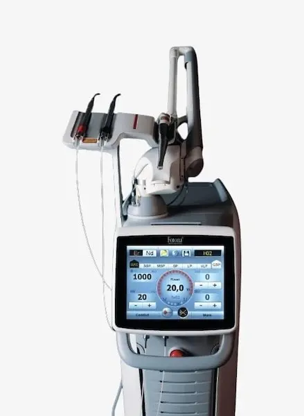 Fotona laser dental treatment system with touchscreen control panel and delivery handpiece.