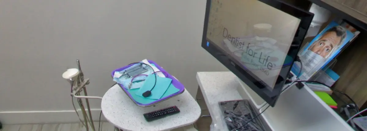 Dental laser therapy equipment displayed in modern dental office treatment room.