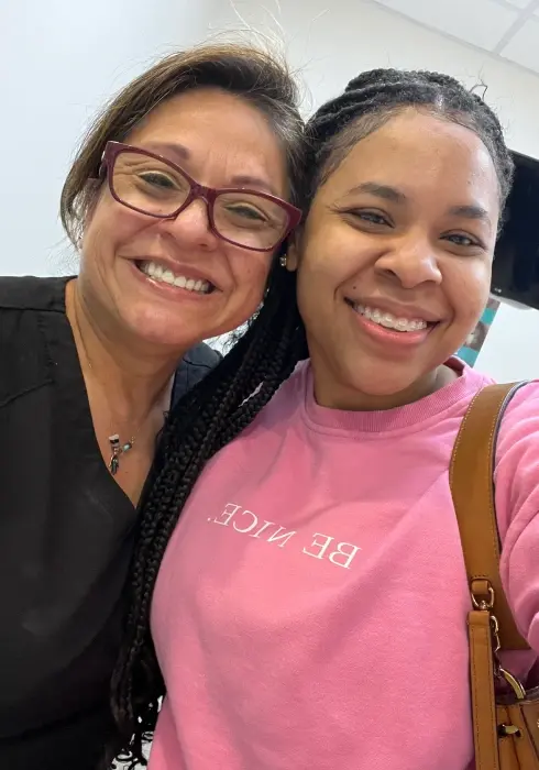 Two smiling women at a dental practice in Plantation, FL.