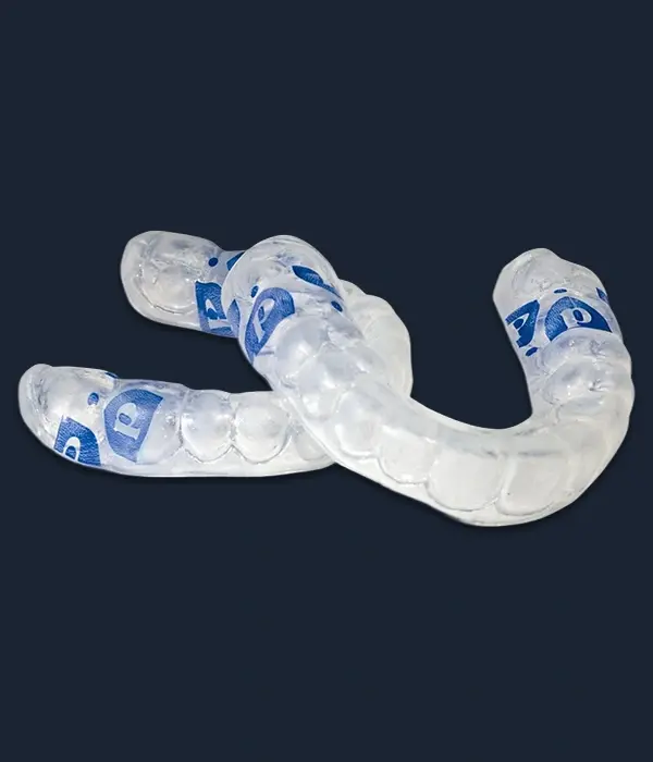 Perio Protect clear aligner trays with blue treatment indicators for periodontal therapy.