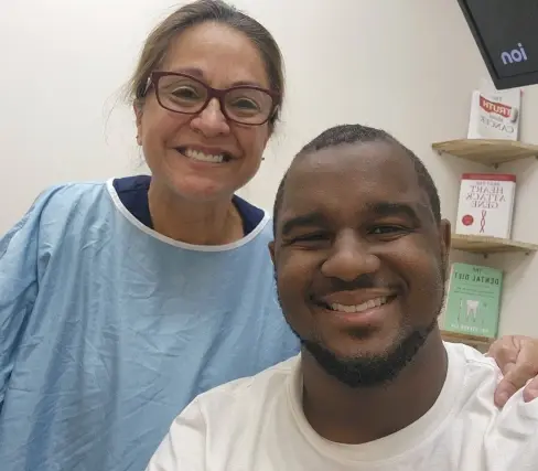 Two smiling team members at a dental practice in Plantation, FL.