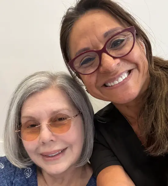 Two women smiling together at a dental practice in Plantation, FL.