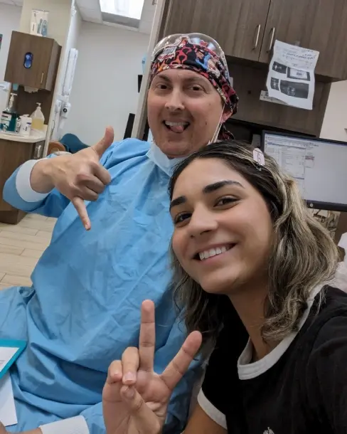Teenage patient and dentist smiling together in Plantation dental office.
